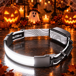 Hokolite COB strip LED headlamp with adjustable strap in a Halloween pumpkin setting