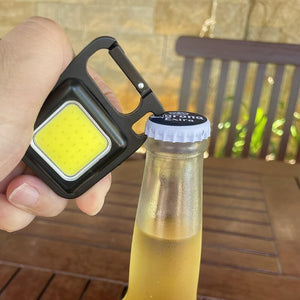 Mini keychain light used as a beer opener